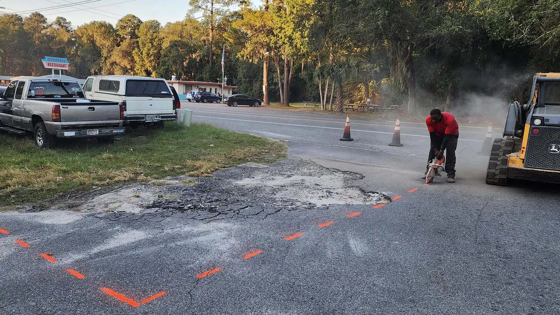 An Employee Of First Coast Asphalt Solution Prepping To Prepare A Pothole