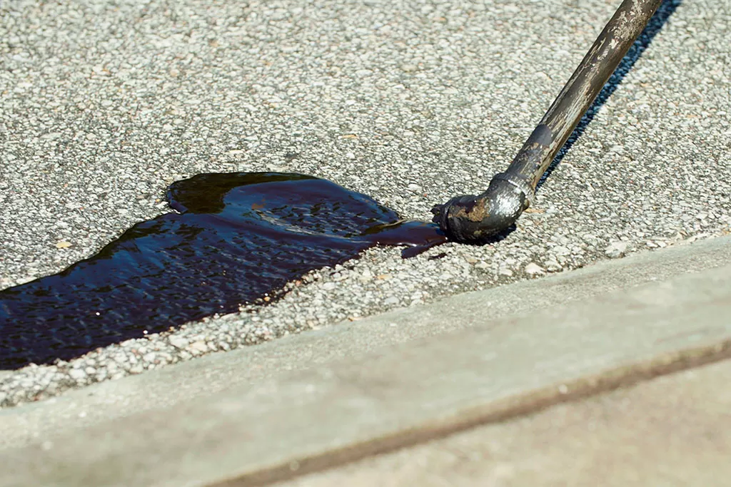 Closeup Of Asphalt Crack Sealing By Jacksonville Fl Contractor